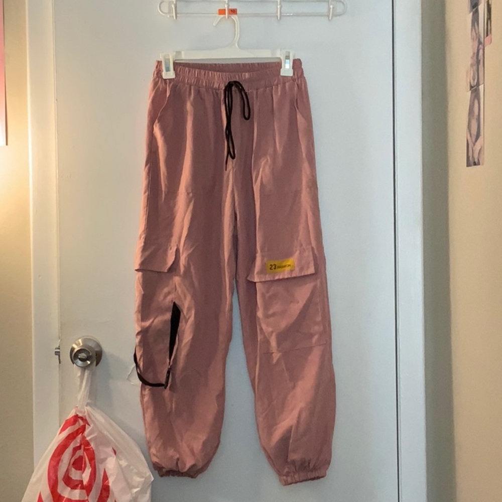 Long pastel pink cargo pants.